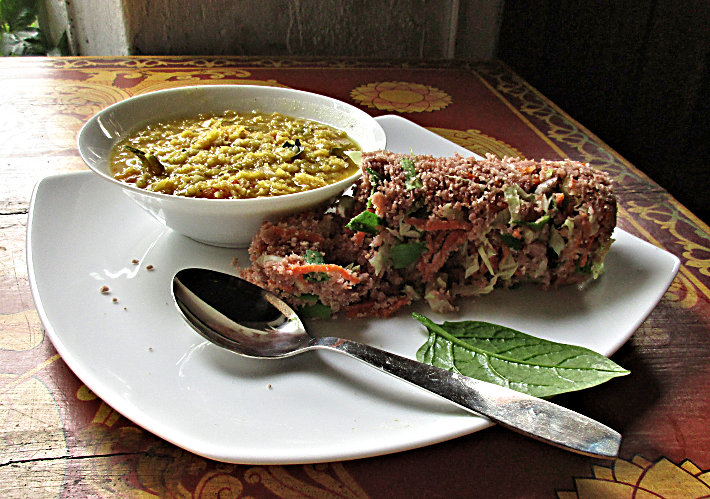 Plate of vegetable pittu with dal curry