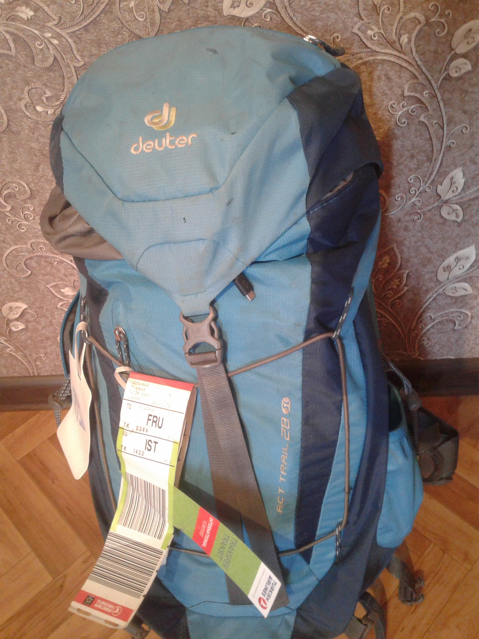 My backpack with checked-luggage tag indicating Bishkek as the destination