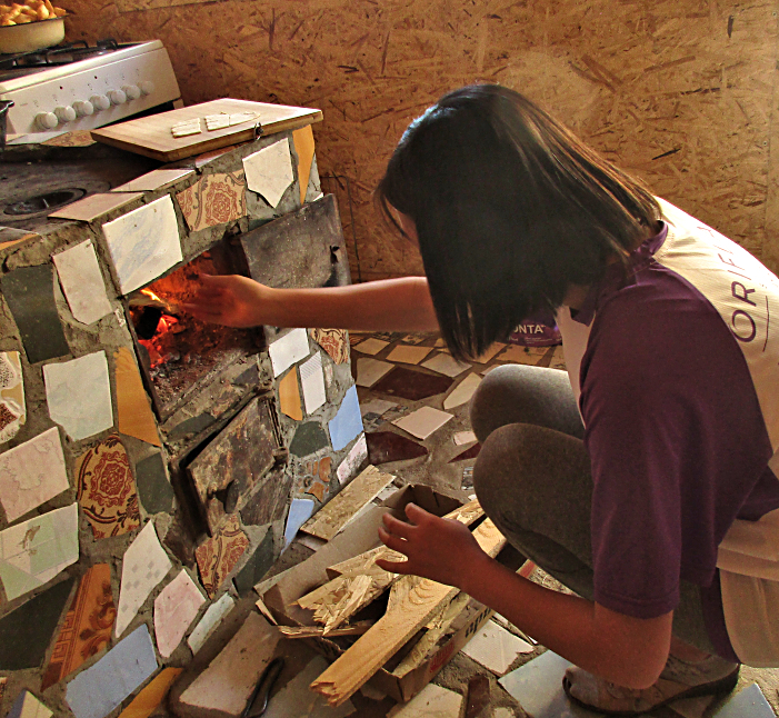 Altynai preparing the wood stove