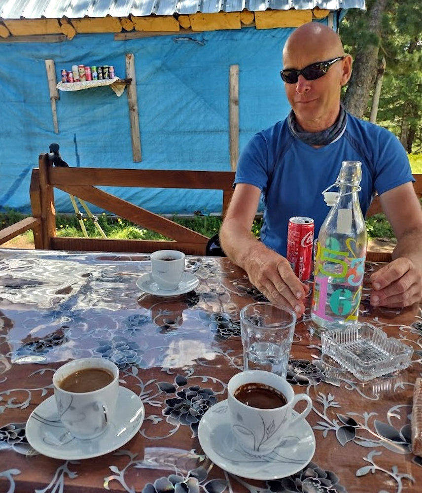 Nev enjoying coffee and cola at a small cafe on the Peaks of the Balkans Tral