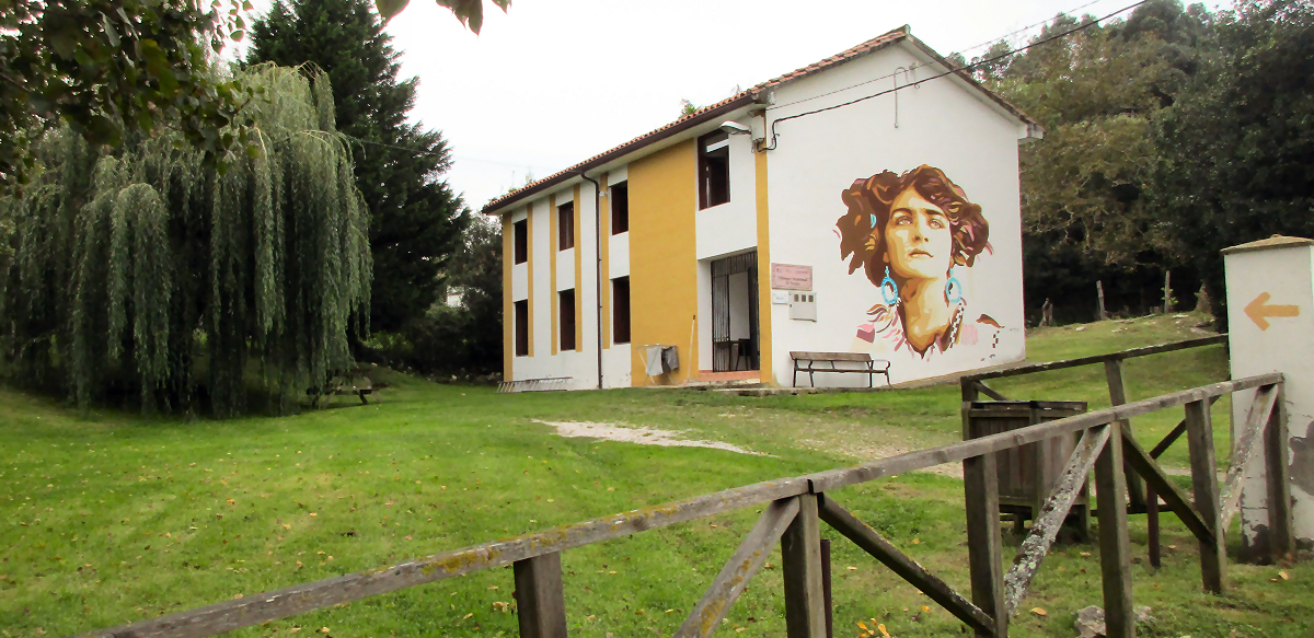Albergue in Serdio with mural of a beautiful woman painted on the side