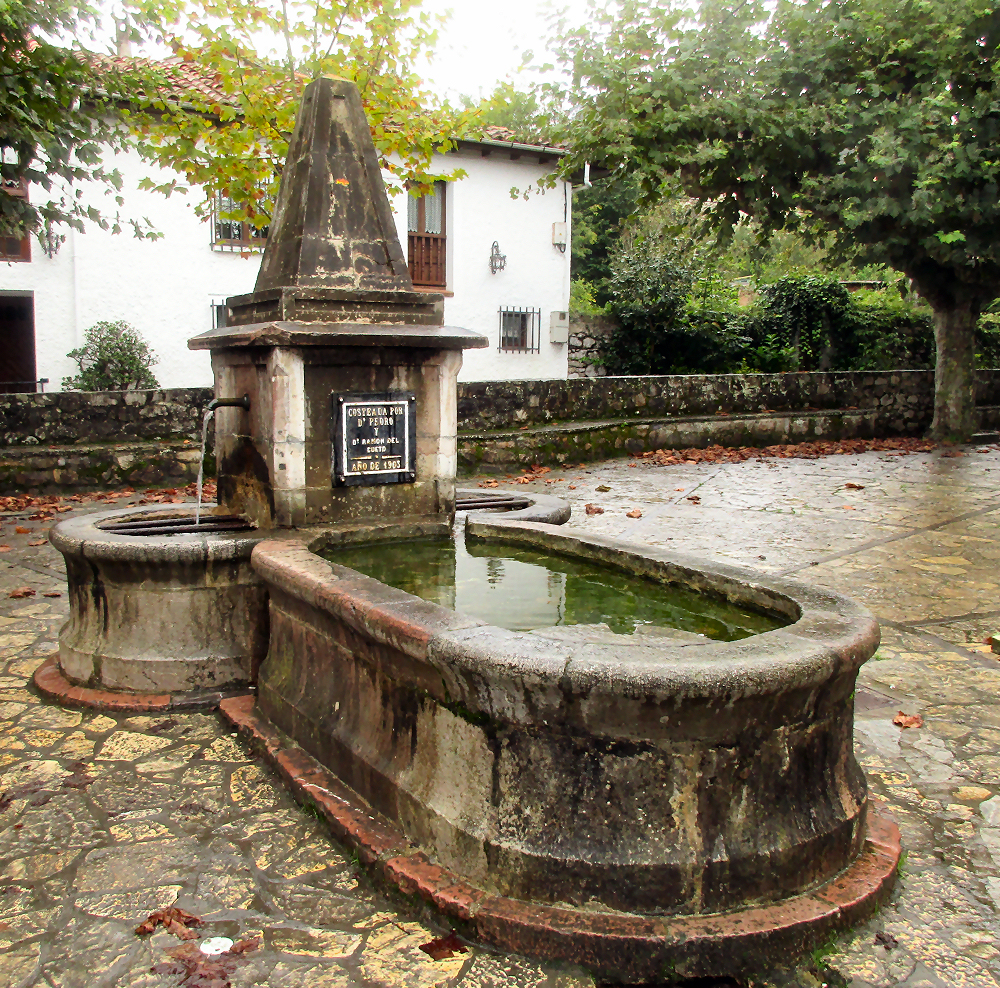 Traditional water fountain in the plaza at Naves, Spain