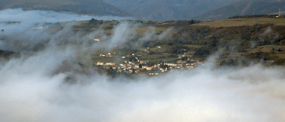 Looking across the reservoir at Grandes de Salime through misty fog clouds