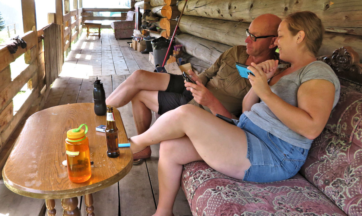 Nev and Rebecca talking on the porch at Guesthouse Lojza