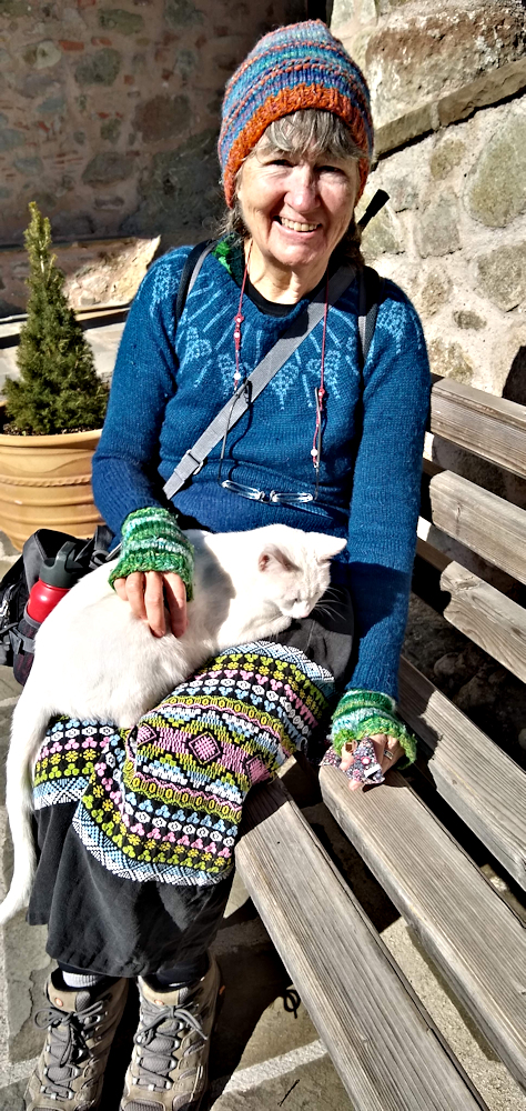 Cahy with a white monastery cat on her lap.