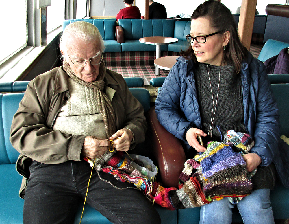 Norman knitting on the Traveling Scarfwhile Robin watches
