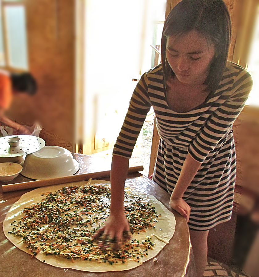 My host preparing Oromo, a traditional Kyrgyz dish