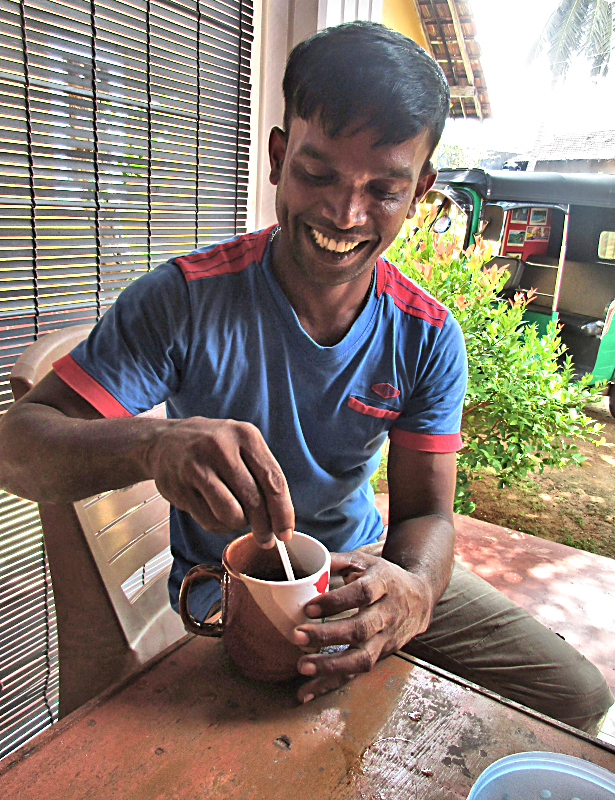 Sampath stirring a cup of tea.