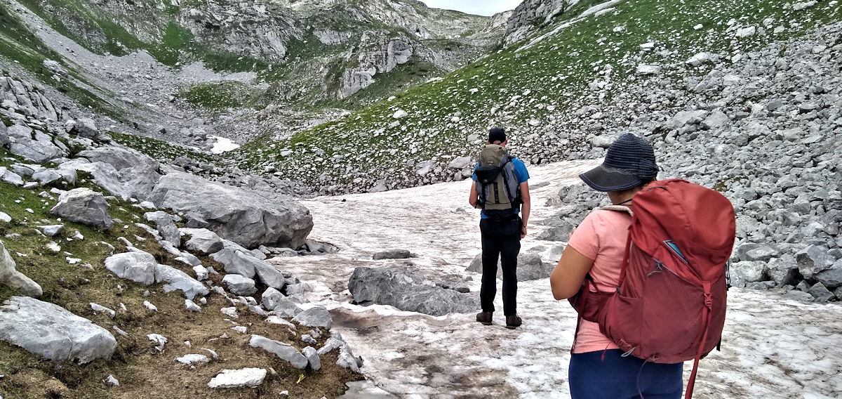 Walking across a patch of Snow in Albanian Alps