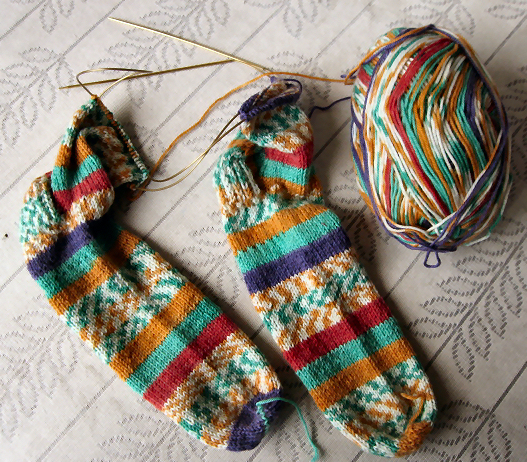 Two socks in the process of being knitted