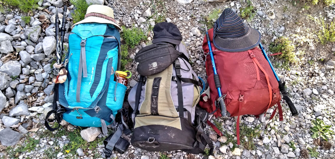 Three backpacks on the ground