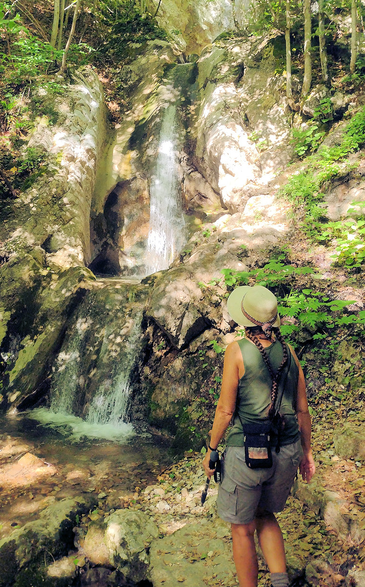 Cathy standing in by one of many waterfalls